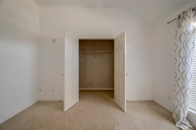 a bathroom with a toilet and a shower curtain