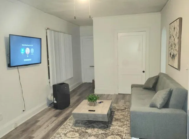 a living room with furniture and a flat screen tv