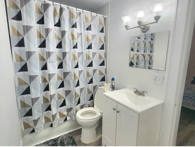a bathroom with a sink toilet and shower