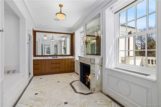 a bathroom with a tub sink and mirror