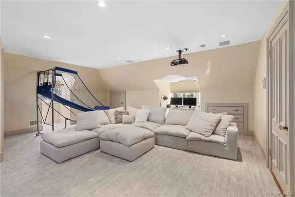 a living room with furniture a ceiling fan and a rug