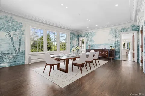 a dining room with furniture window and wooden floor