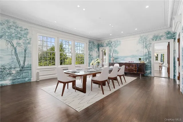 a dining room with furniture window and wooden floor