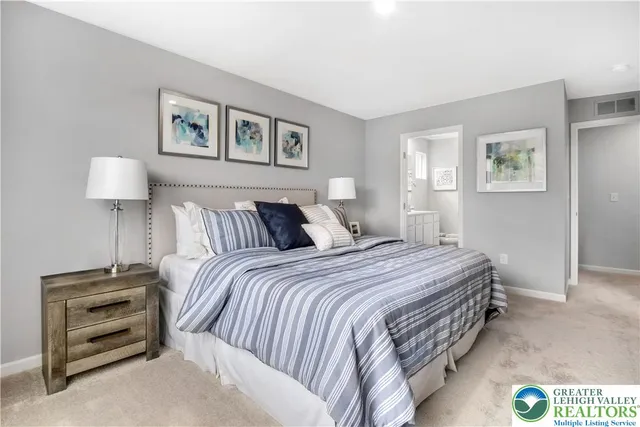 a bedroom with a bed and a night stand