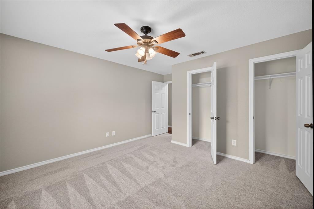 9660 Timberleaf Drive Dallas, TX 75243 - Photo 23 of 40 Spacious room featuring neutral paint, light-toned carpet, white trim, and a ceiling fan with light fixture