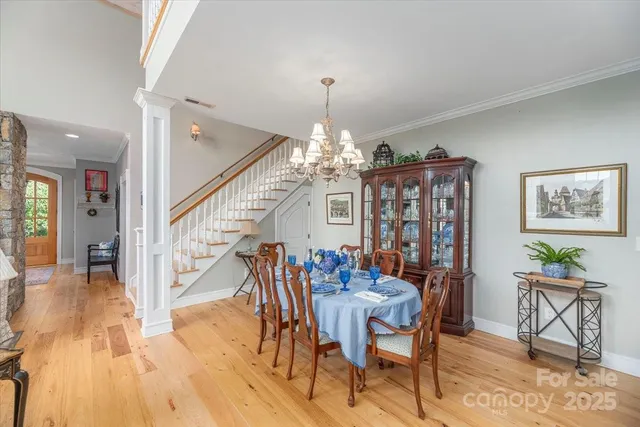 a view of a dining room with furniture wooden floor and a chandelier