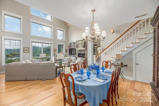 a view of a dining room with furniture a chandelier and wooden floor