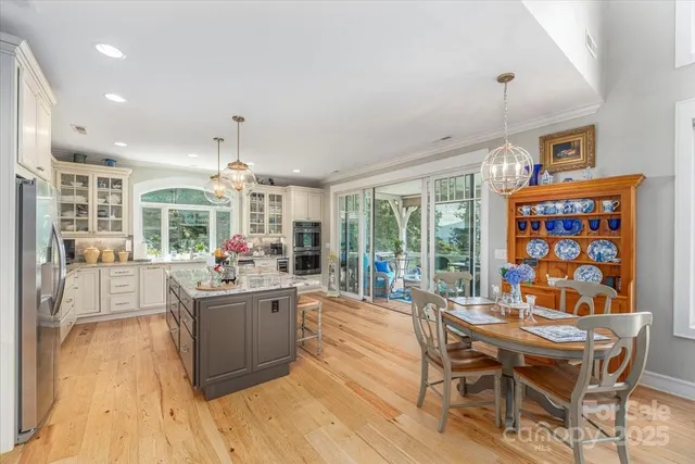 a living room with fireplace furniture and a large window
