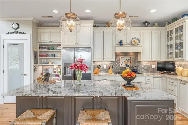 a kitchen with granite countertop a sink cabinets and window