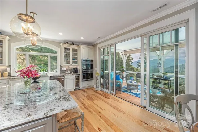 a view of a glass door with a door and wooden floor