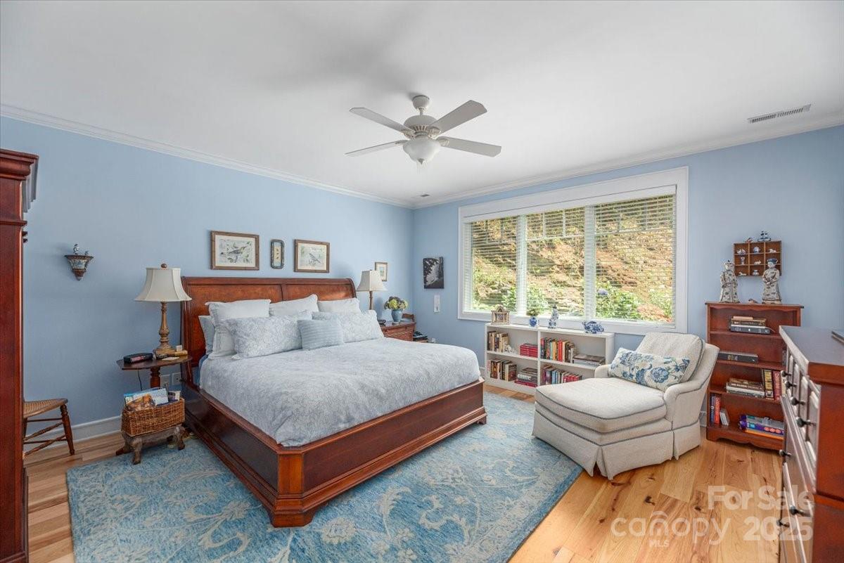 316 Fincher Mountain Road Waynesville, NC 28785 - Photo 28 of 46 a bedroom with a bed and wooden floor