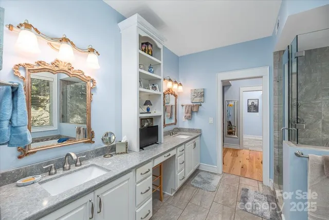 a bathroom with a tub a sink and a shower