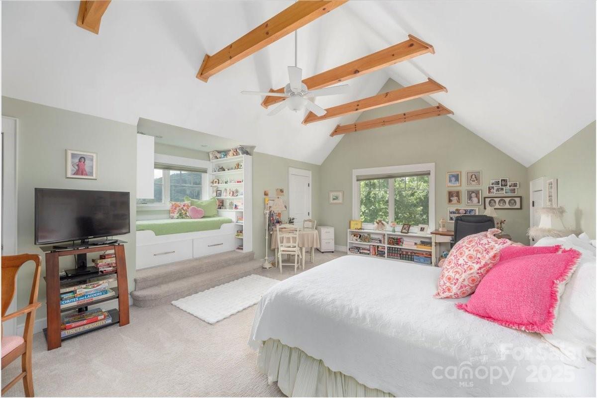 316 Fincher Mountain Road Waynesville, NC 28785 - Photo 35 of 46 a bedroom with a bed and a flat screen tv