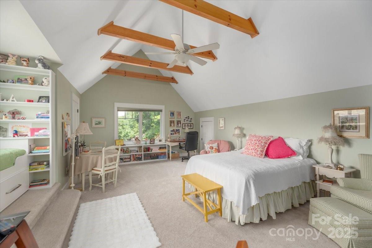 316 Fincher Mountain Road Waynesville, NC 28785 - Photo 36 of 46 a bedroom with a bed a chandelier and dresser