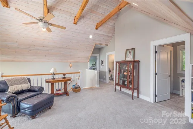 a bedroom with furniture and a large window