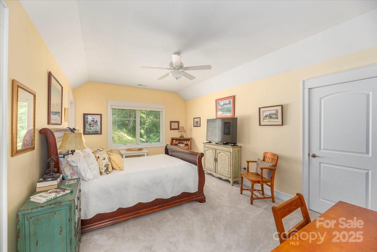 316 Fincher Mountain Road Waynesville, NC 28785 - Photo 41 of 46 a bedroom with furniture and a large window