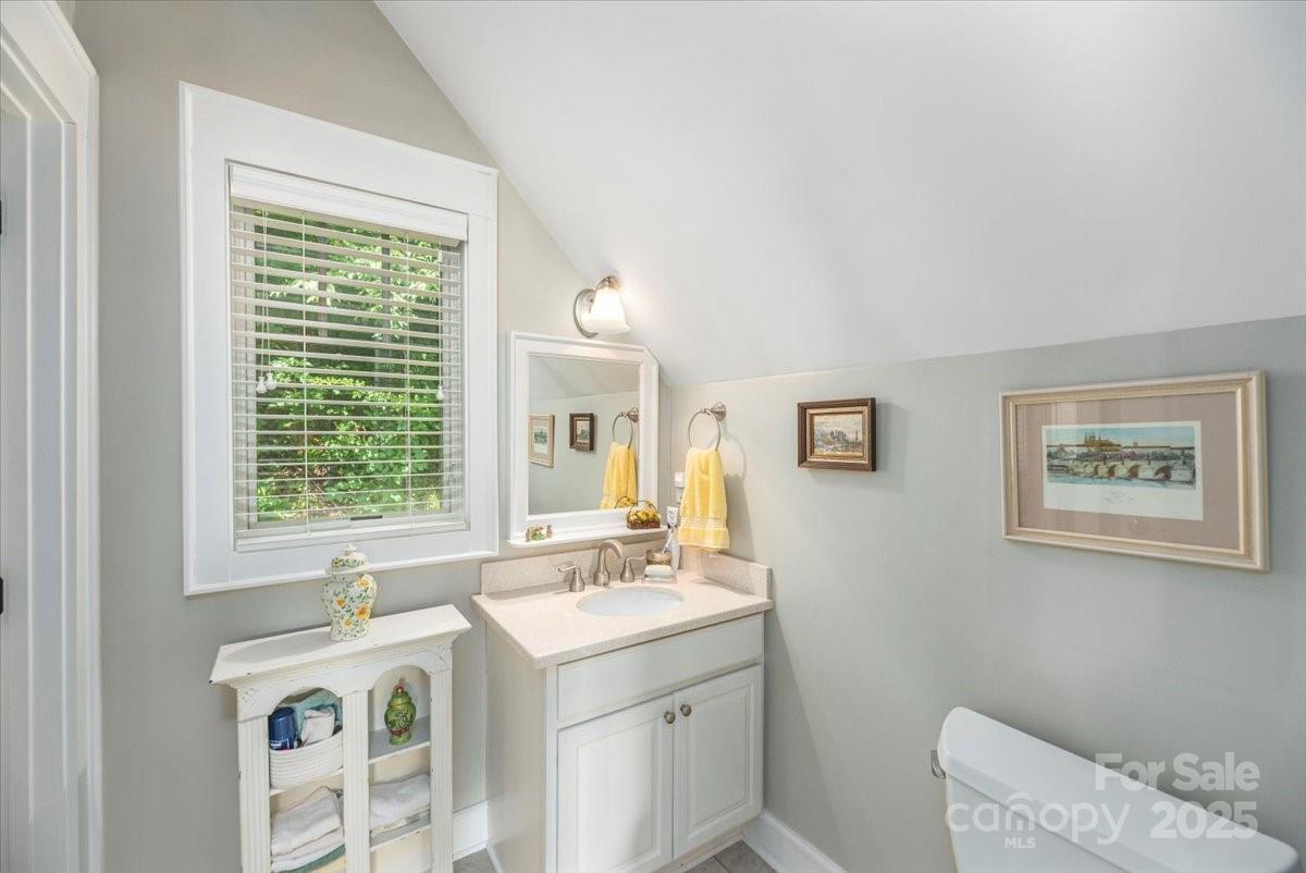 316 Fincher Mountain Road Waynesville, NC 28785 - Photo 42 of 46 a bathroom with a sink a large mirror and a window