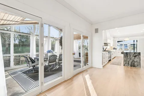 a white bath tub sitting in a bathroom next to a window