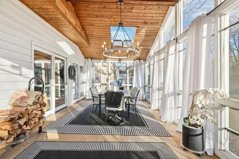 a spacious bathroom with a sink a vanity a mirror and bathtub