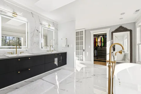 a view of an empty room with a window and closet