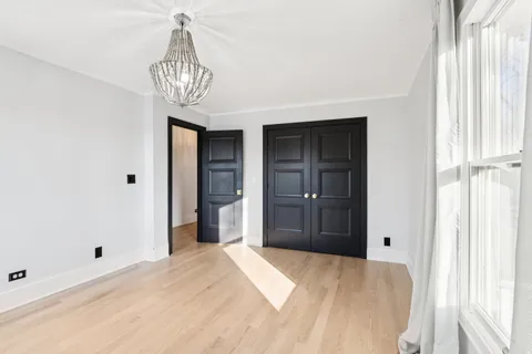 a large bedroom with a bed and a fireplace