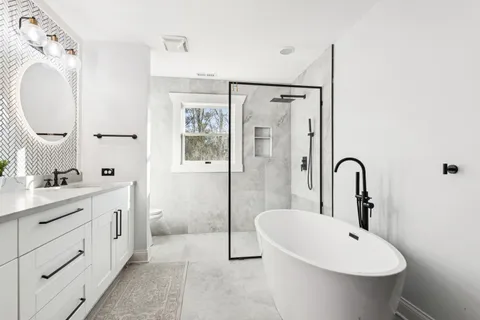 a bathroom with a granite countertop sink a toilet and shower
