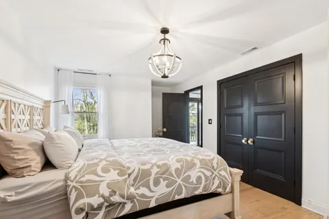 a view of a backyard with sitting area and lake view