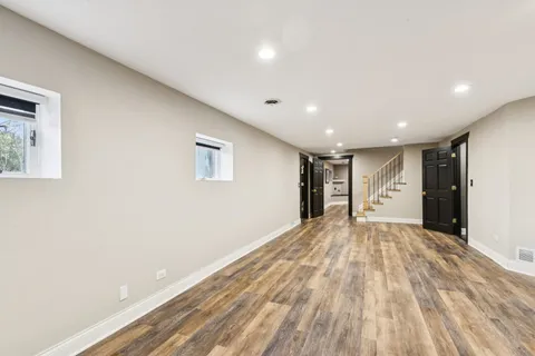 a front view of a house with a garden and plants
