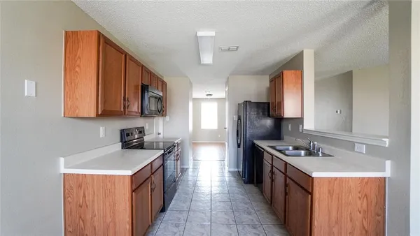 a kitchen with stainless steel appliances a sink stove and cabinets