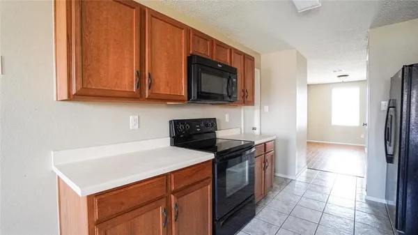 a kitchen with stainless steel appliances a stove a microwave a sink and cabinets