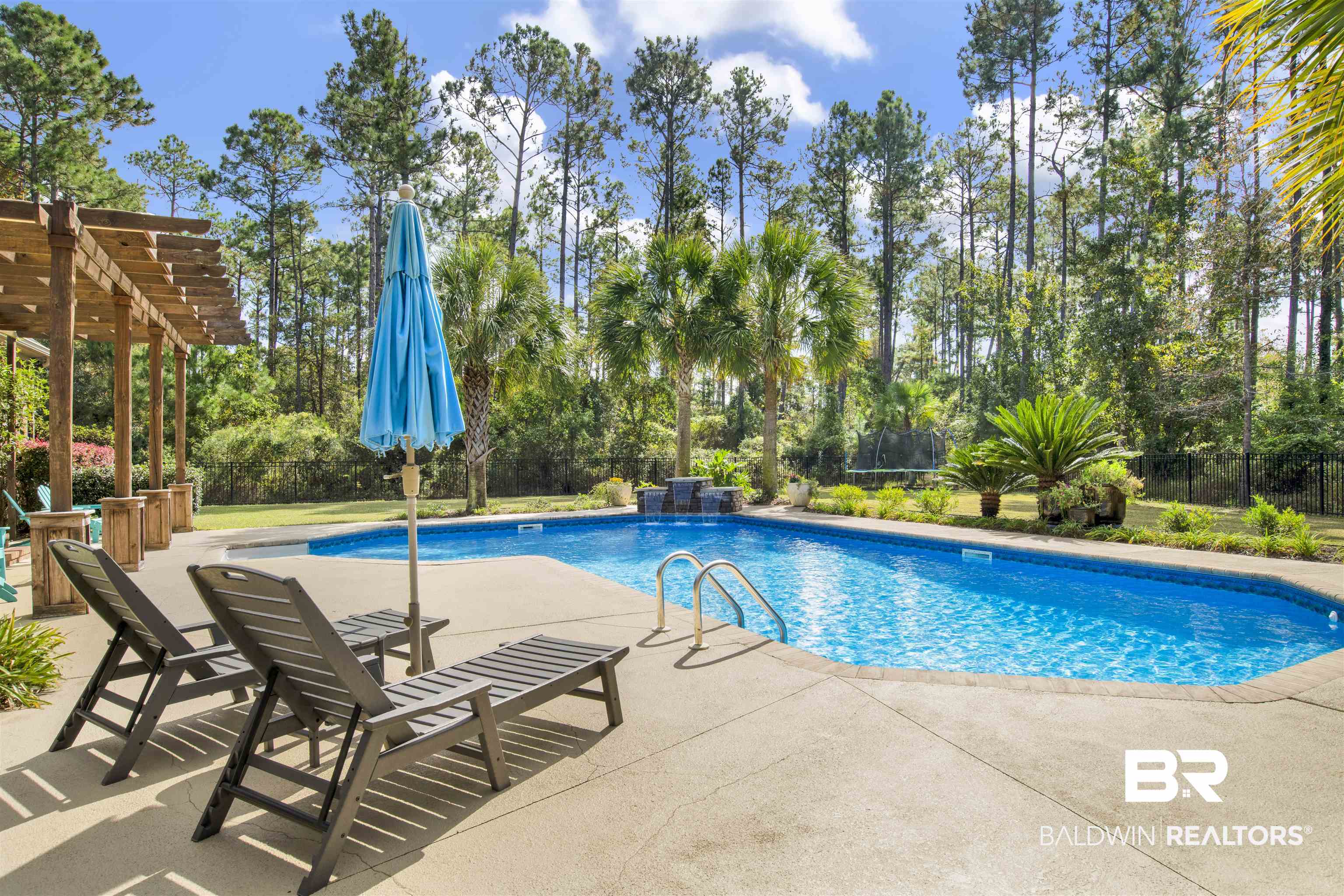 18360 Treasure Oaks Road Gulf Shores, AL 36542 - Photo 27 of 57 View of swimming pool featuring pool water feature, a pergola, a trampoline, and a patio area