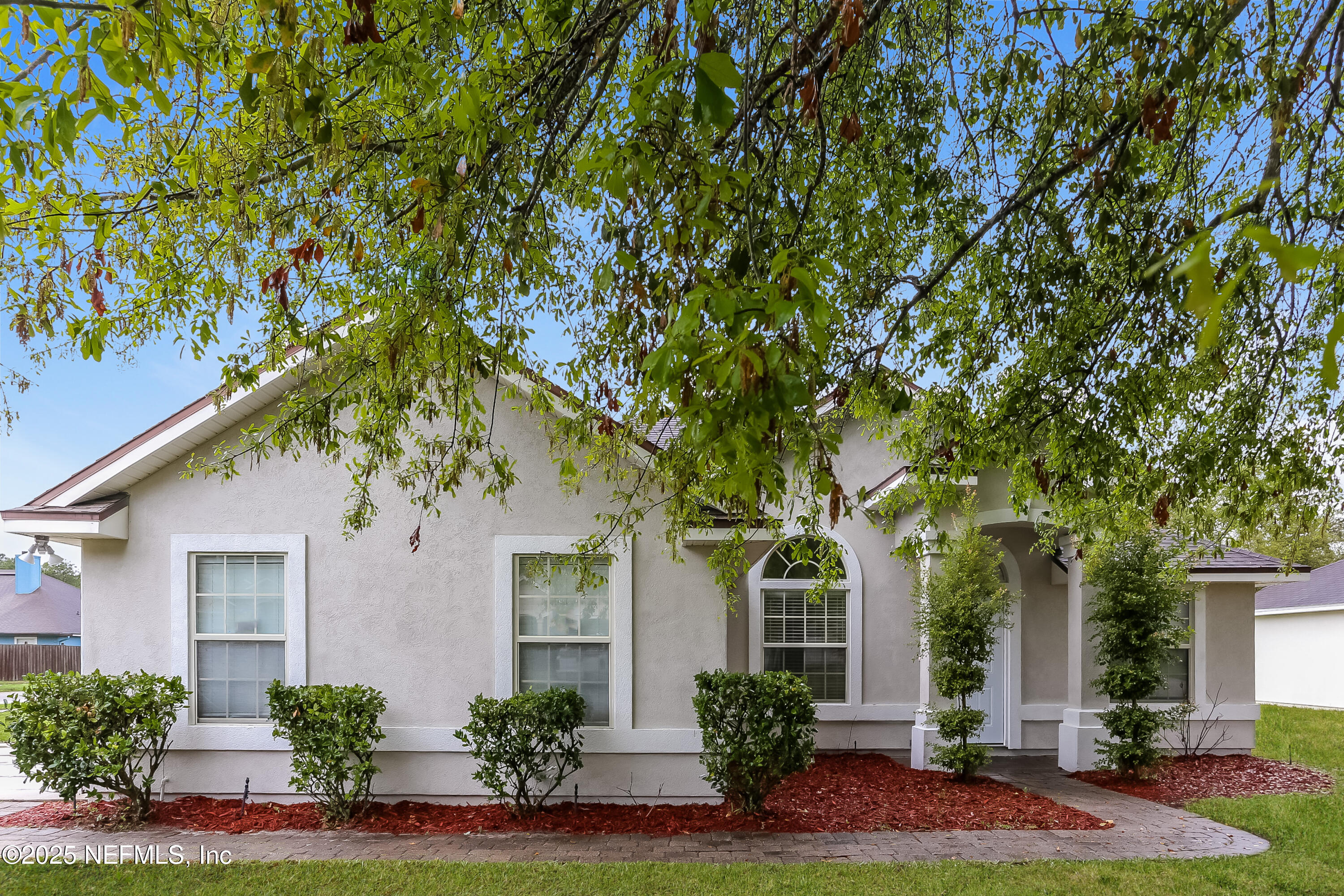 86016 Cherry Laurel Way Yulee, FL 32097 - Photo 1 of 15 a front view of a house with porch