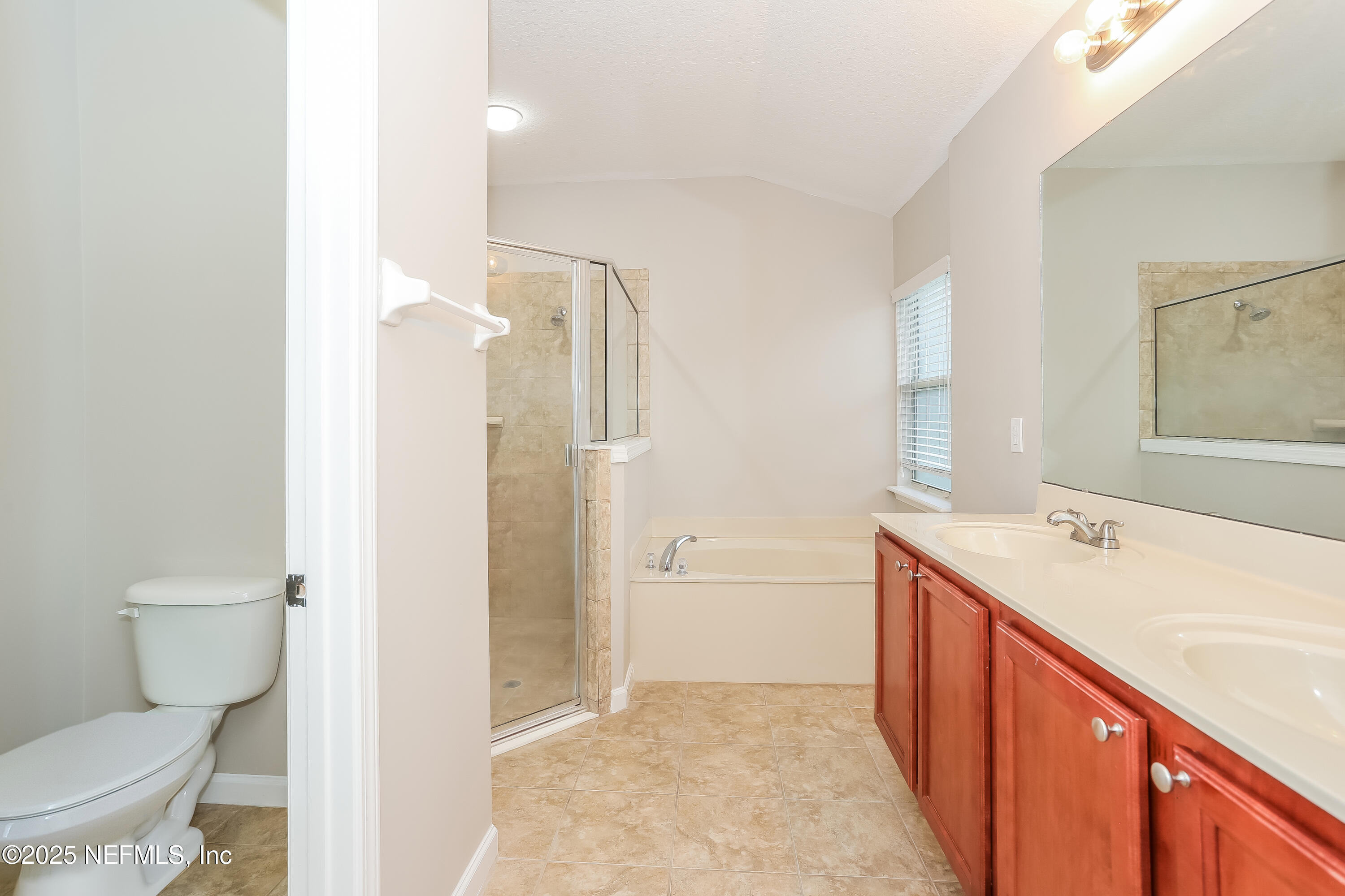 86016 Cherry Laurel Way Yulee, FL 32097 - Photo 11 of 15 a bathroom with a sink a toilet and shower