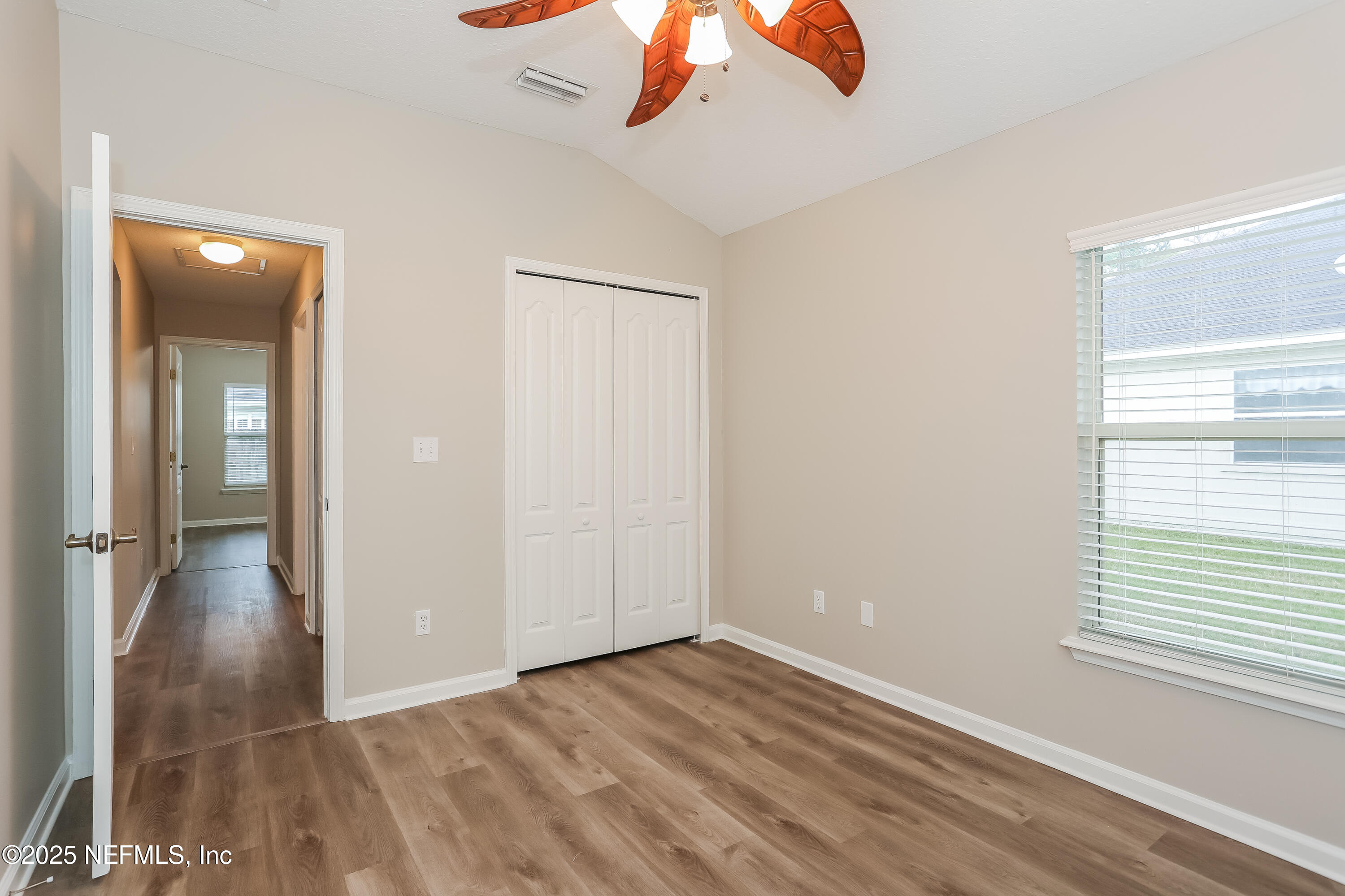 86016 Cherry Laurel Way Yulee, FL 32097 - Photo 12 of 15 wooden floor in an empty room with a window