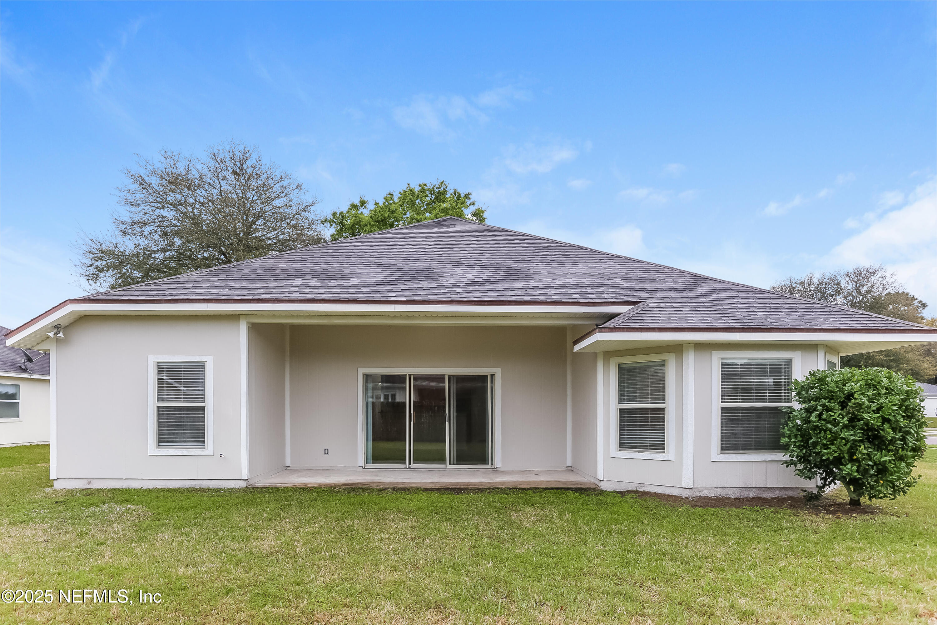 86016 Cherry Laurel Way Yulee, FL 32097 - Photo 14 of 15 a front view of a house with a yard garage and outdoor seating