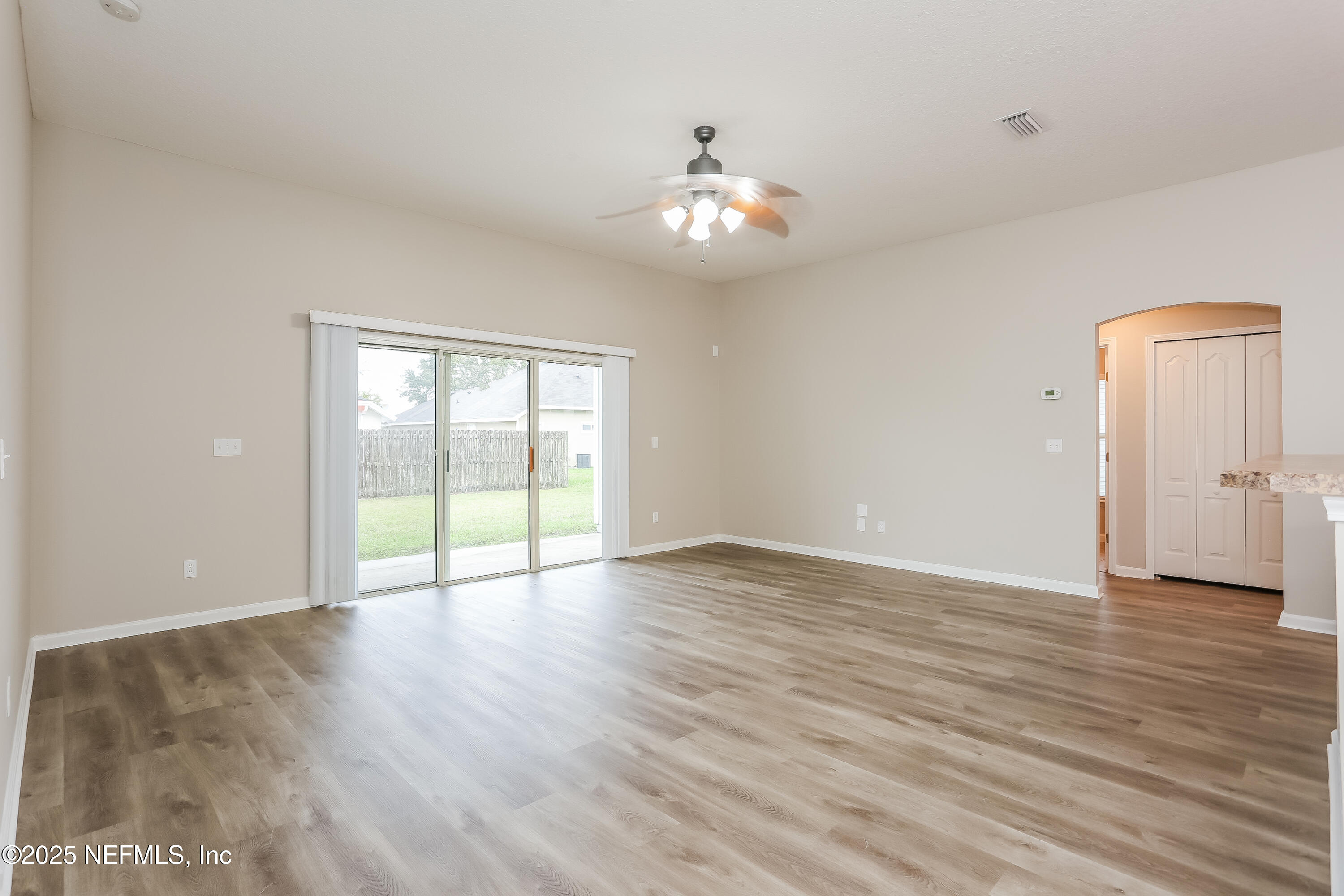 86016 Cherry Laurel Way Yulee, FL 32097 - Photo 3 of 15 a view of an empty room with wooden floor and a window