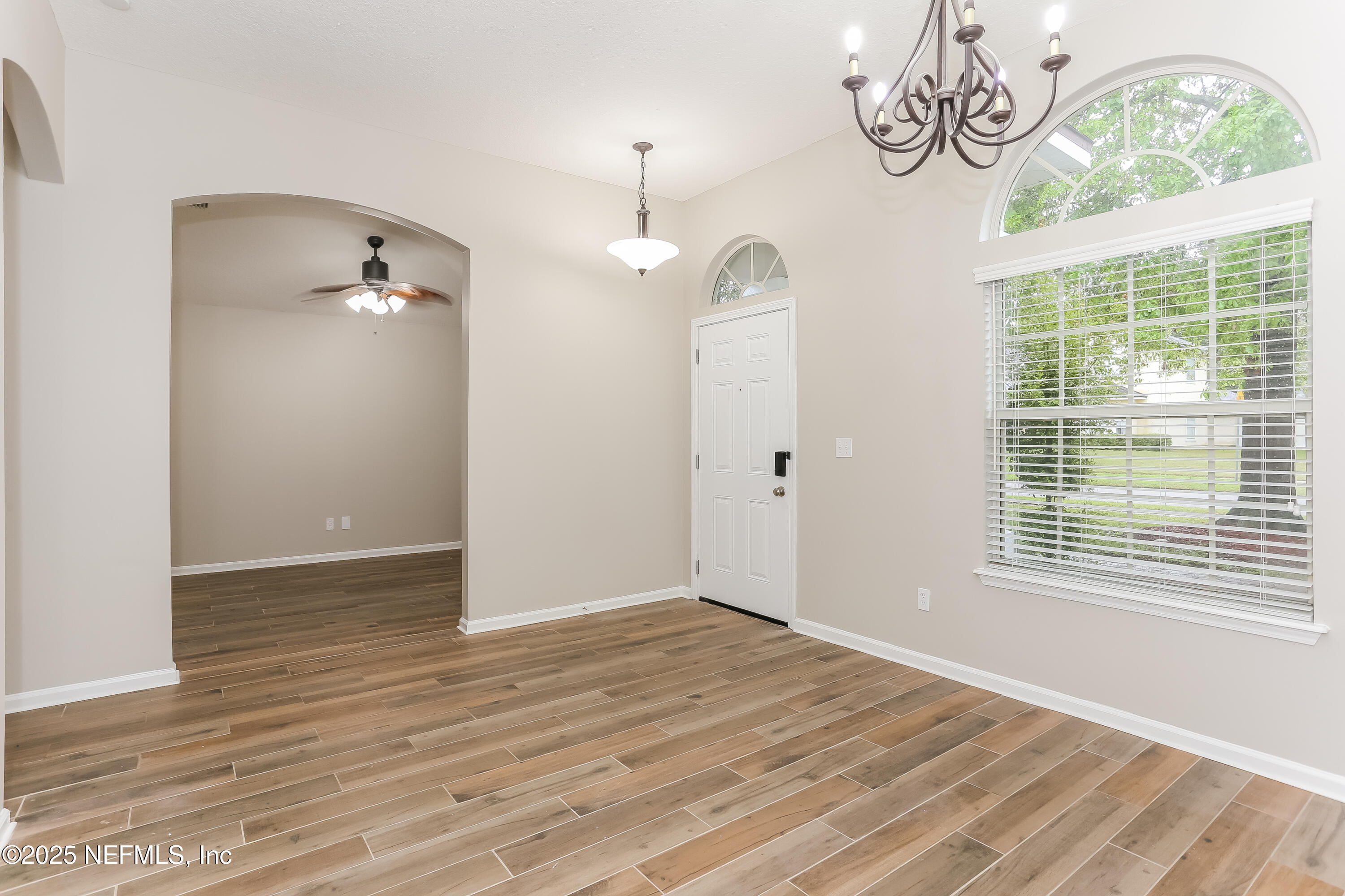 86016 Cherry Laurel Way Yulee, FL 32097 - Photo 4 of 15 a view of an empty room with window and wooden floor