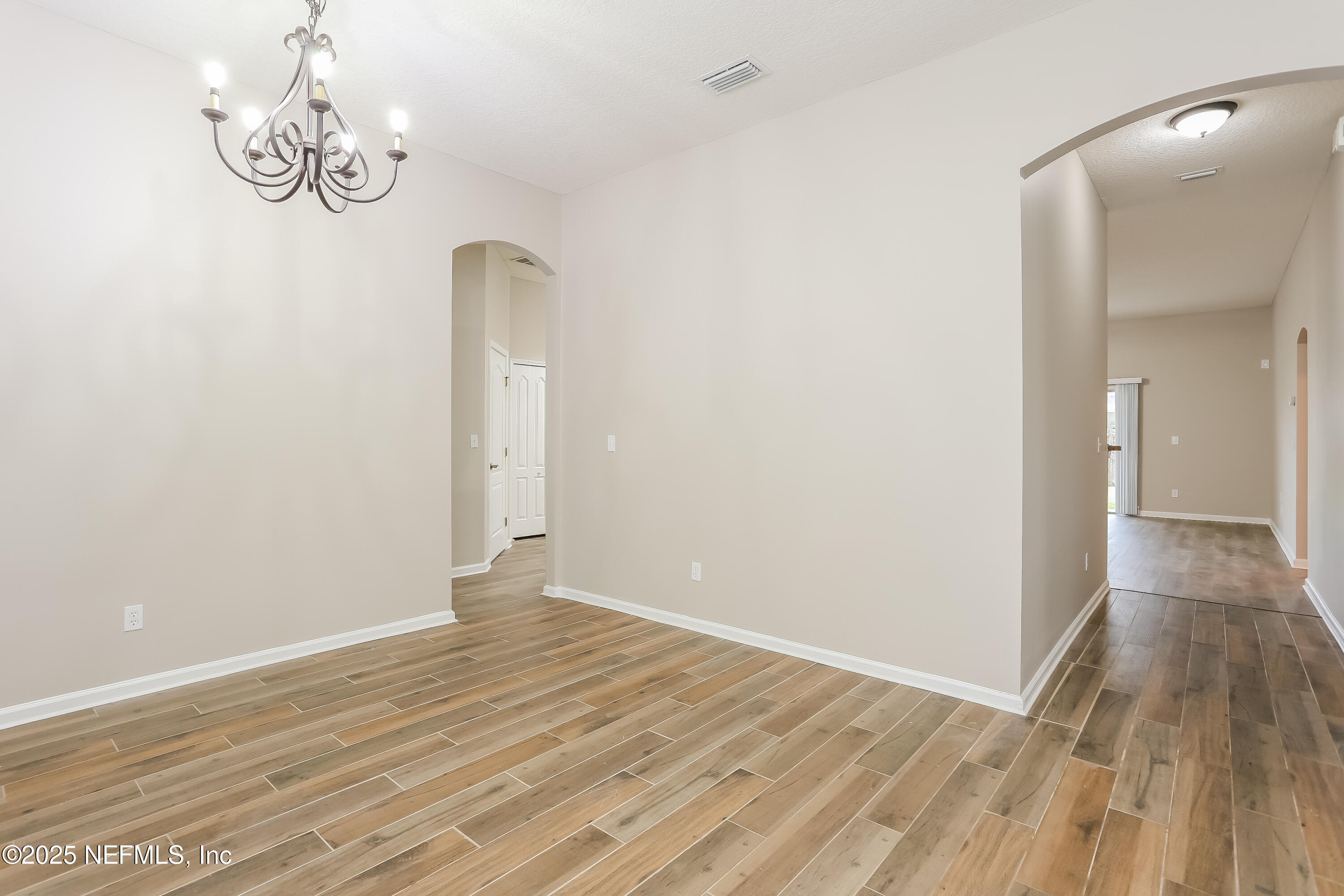 86016 Cherry Laurel Way Yulee, FL 32097 - Photo 5 of 15 a view of a room with wooden floor and white walls