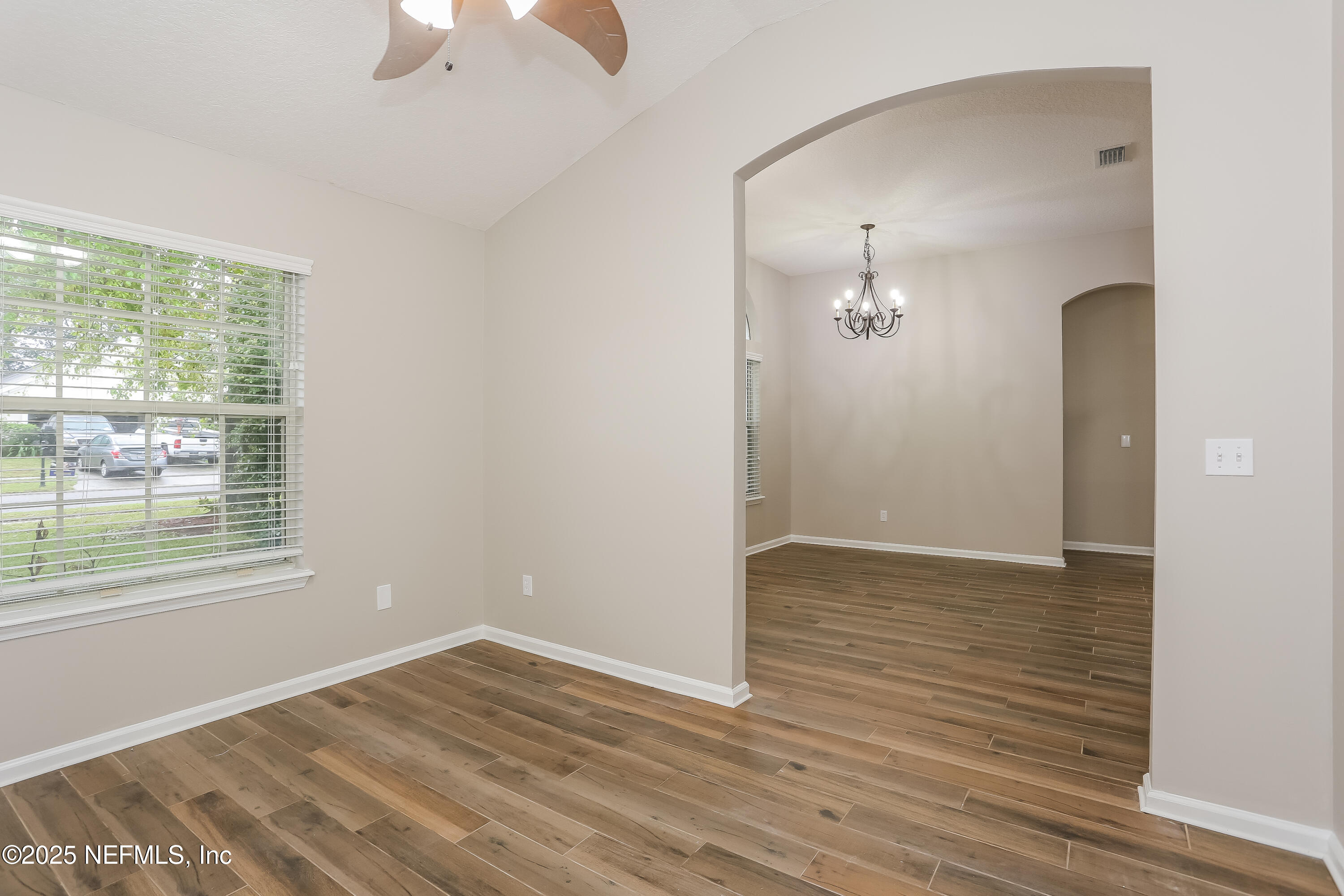86016 Cherry Laurel Way Yulee, FL 32097 - Photo 8 of 15 an empty room with wooden floor and windows