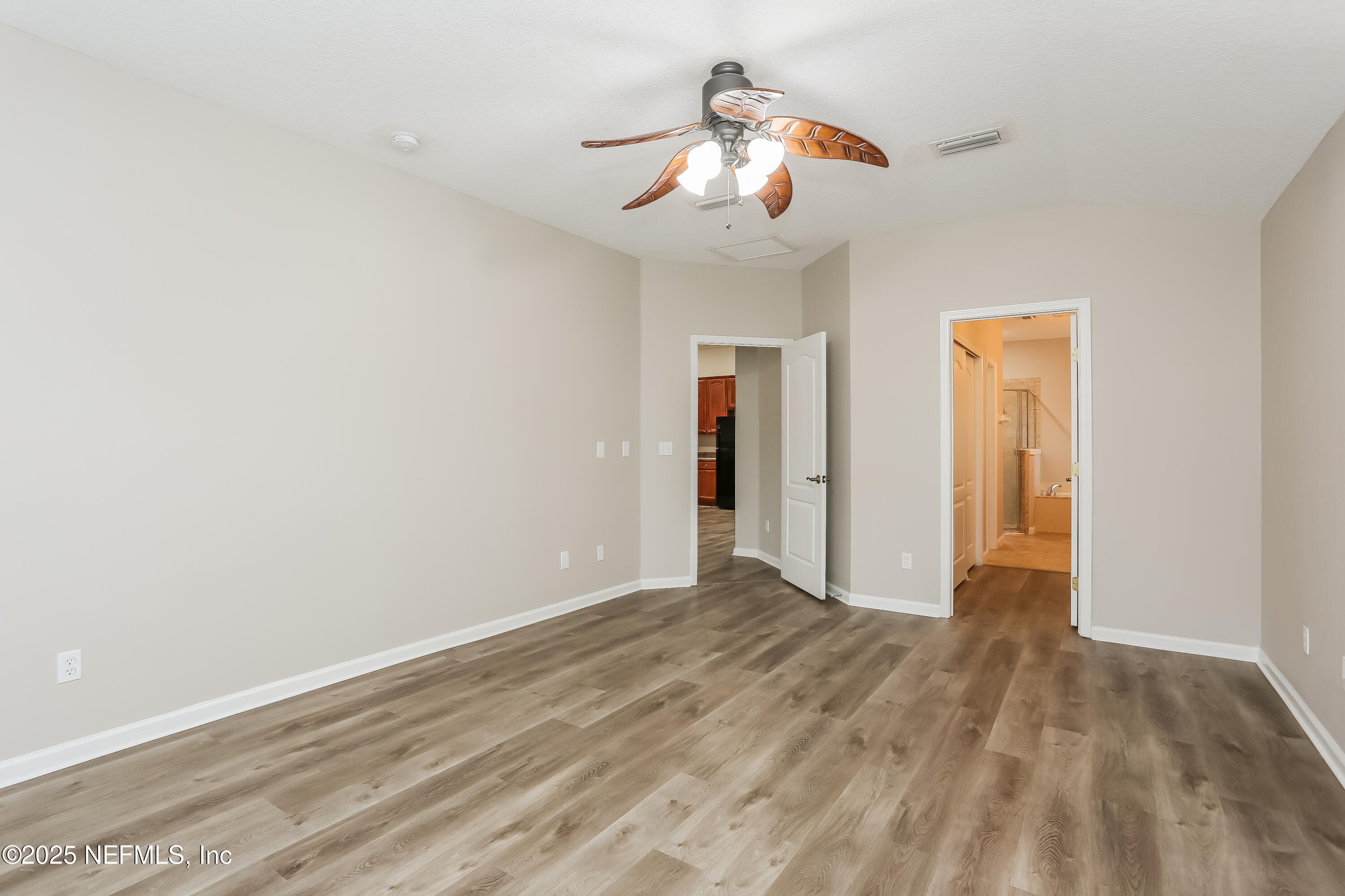 86016 Cherry Laurel Way Yulee, FL 32097 - Photo 9 of 15 a view of a livingroom with wooden floor and a ceiling fan