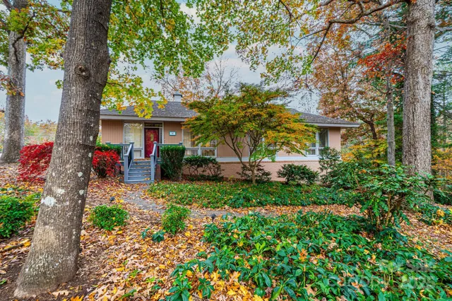 a view of house with a yard and garden