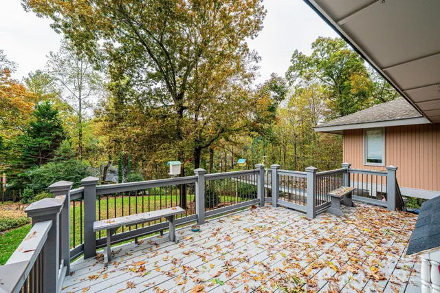 a view of a wooden chairs and table in the deck