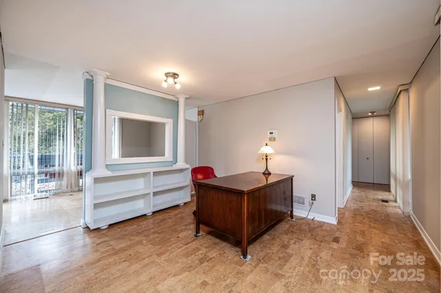 a view of a bedroom with furniture window and wooden floor