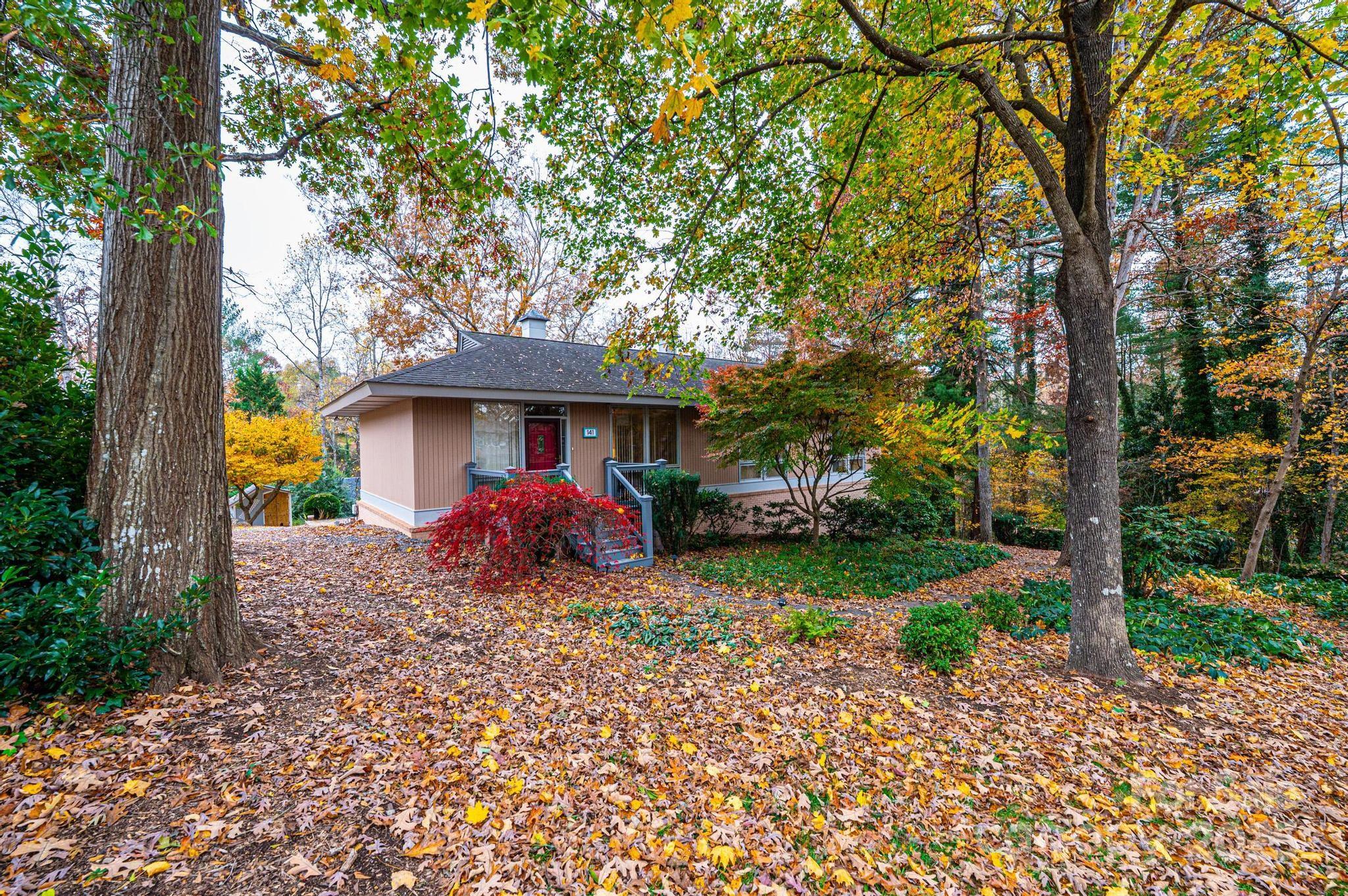 141 36th Avenue Northwest Hickory, NC 28601 - Photo 2 of 46 a view of a house with a small yard and large trees