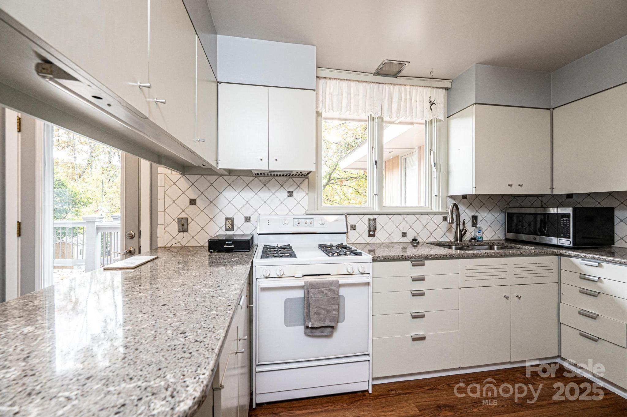 141 36th Avenue Northwest Hickory, NC 28601 - Photo 22 of 46 a kitchen with granite countertop a sink a window stainless steel appliances and cabinets