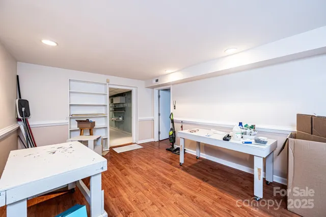 a view of a workspace with furniture and wooden floor