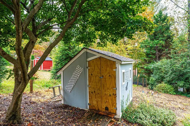 a view of a house with a tree in the background