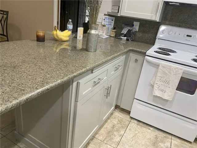 a kitchen with a sink a stove and cabinets