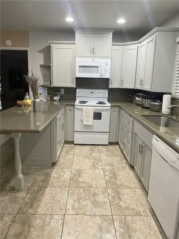 a kitchen with a stove top oven sink and cabinets