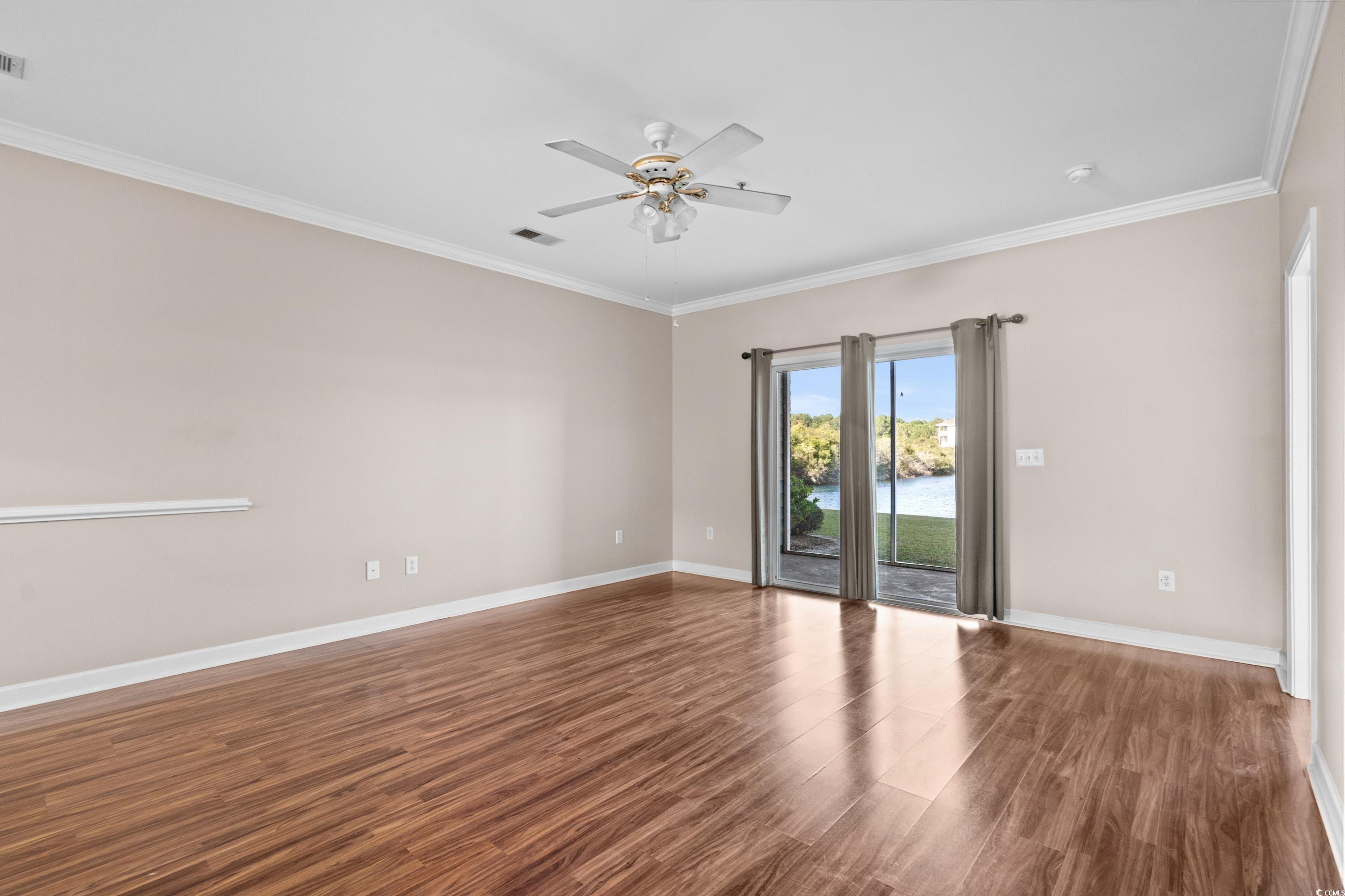 336 Kiskadee Loop, Unit B Conway, SC 29526 - Photo 8 of 40 Spare room featuring a water view, ceiling fan, ornamental molding, and dark hardwood / wood-style floors